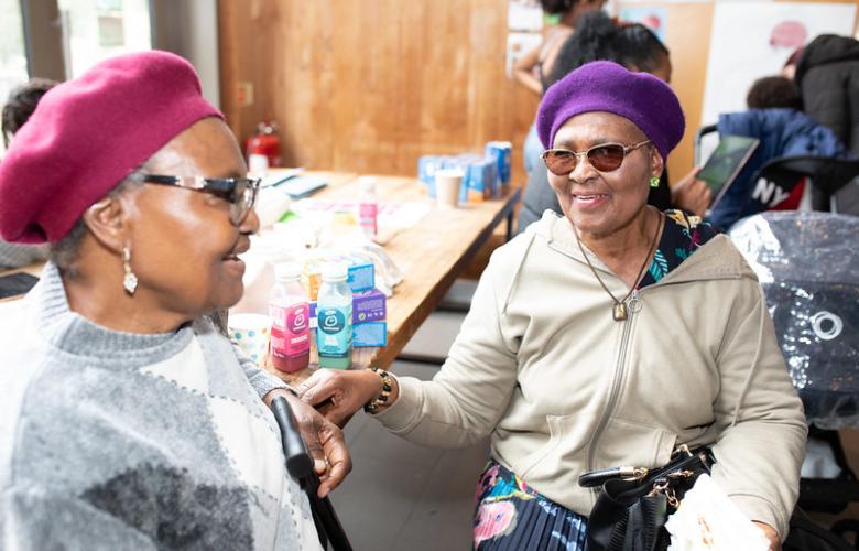 Two women sitting around a table talking